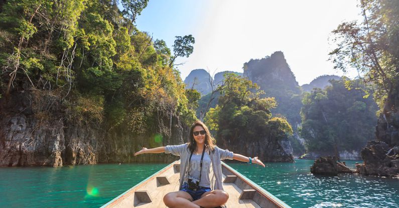 Adventure Tours - Photo of Woman Sitting on Boat Spreading Her Arms