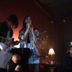 Karaoke Bars - A Woman Singing on Stage