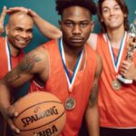 Sports Events - Three Men in Orange Jersey Shirt Holding Basketball