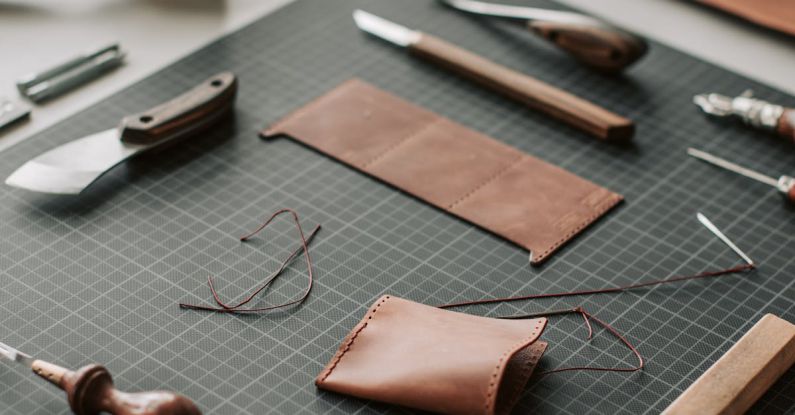 Handcrafted Goods - Tools and Leather Lying on a Desk in a Leather Crafting Workshop