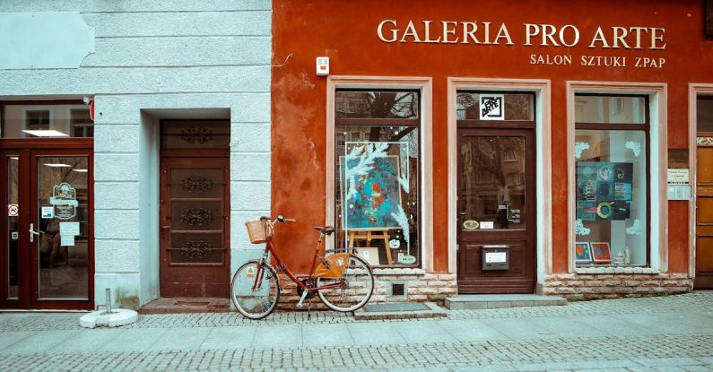 Art Galleries - A bicycle parked outside of a building with a sign that says gallery art